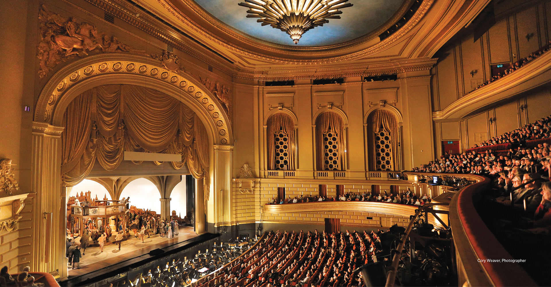 War Memorial Opera House interior house right with production onstage and a live audience.